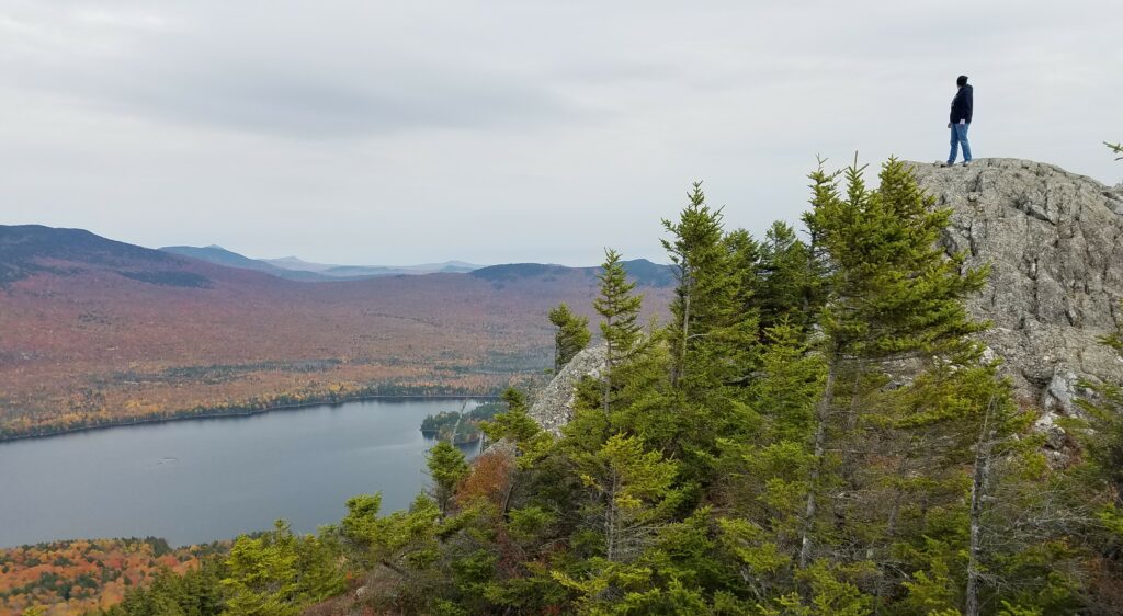 author Emma G Rose stands on a peak at Borestone Mountain