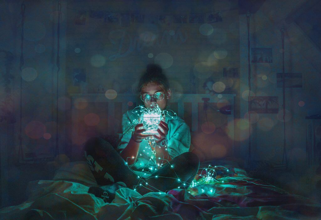 Girl holds a string of lights