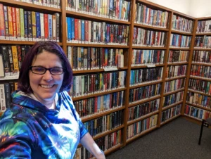 Emma at her local library, the cheapest way to read books is with a library card